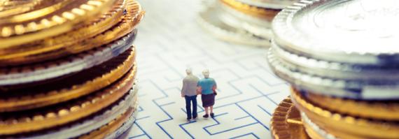 small senior couple figurine walking through a maze of money
